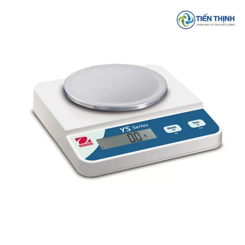 Cân điện tử màu trắng, mặt tròn, hiển thị số, dùng trong phòng thí nghiệm.