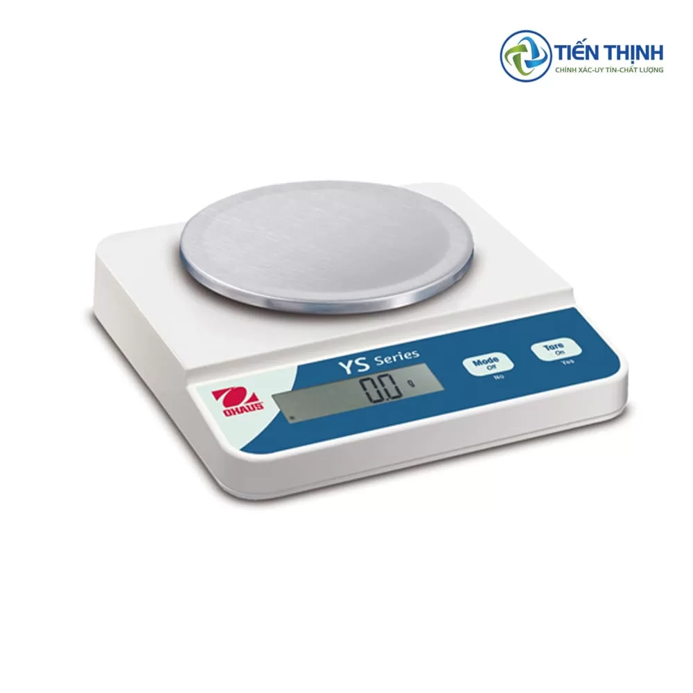 Cân điện tử màu trắng, mặt tròn, hiển thị số, dùng trong phòng thí nghiệm.