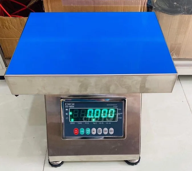 Cân điện tử với mặt bàn màu xanh dương và màn hình hiển thị số.