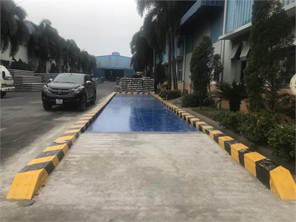 Cân xe tải lớn với xe ô tô đang chờ đo trọng lượng.