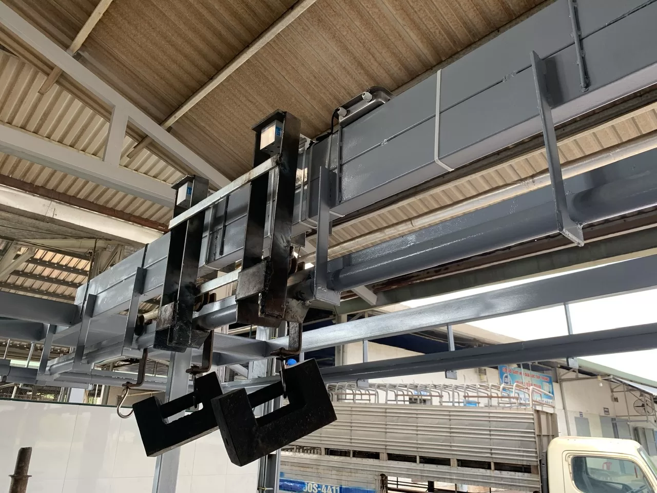 Cần trục từ tính công nghiệp nâng phế liệu sắt thép trong nhà xưởng.